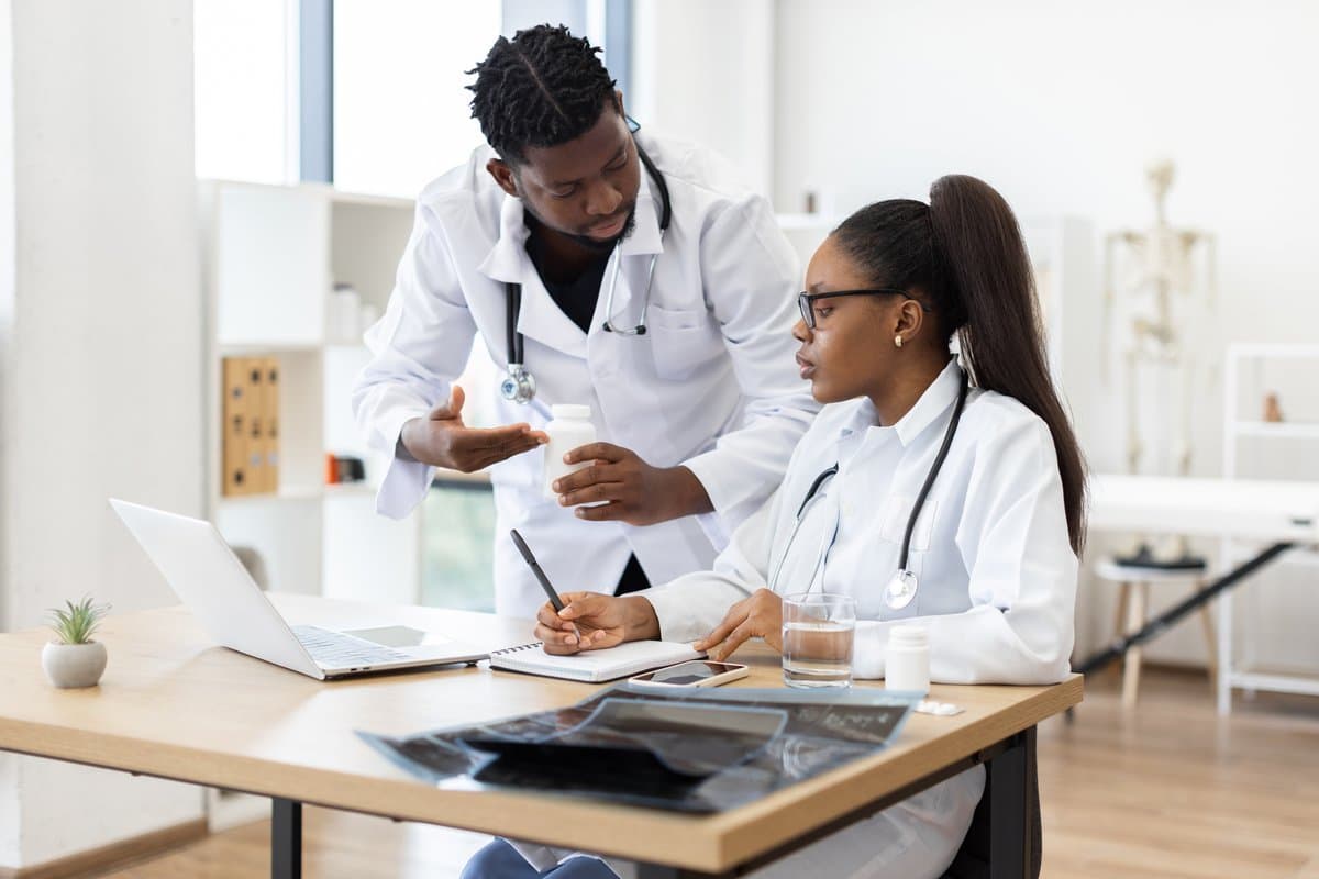 Healthcare team discussing weekly roster assignments and coverage requirements