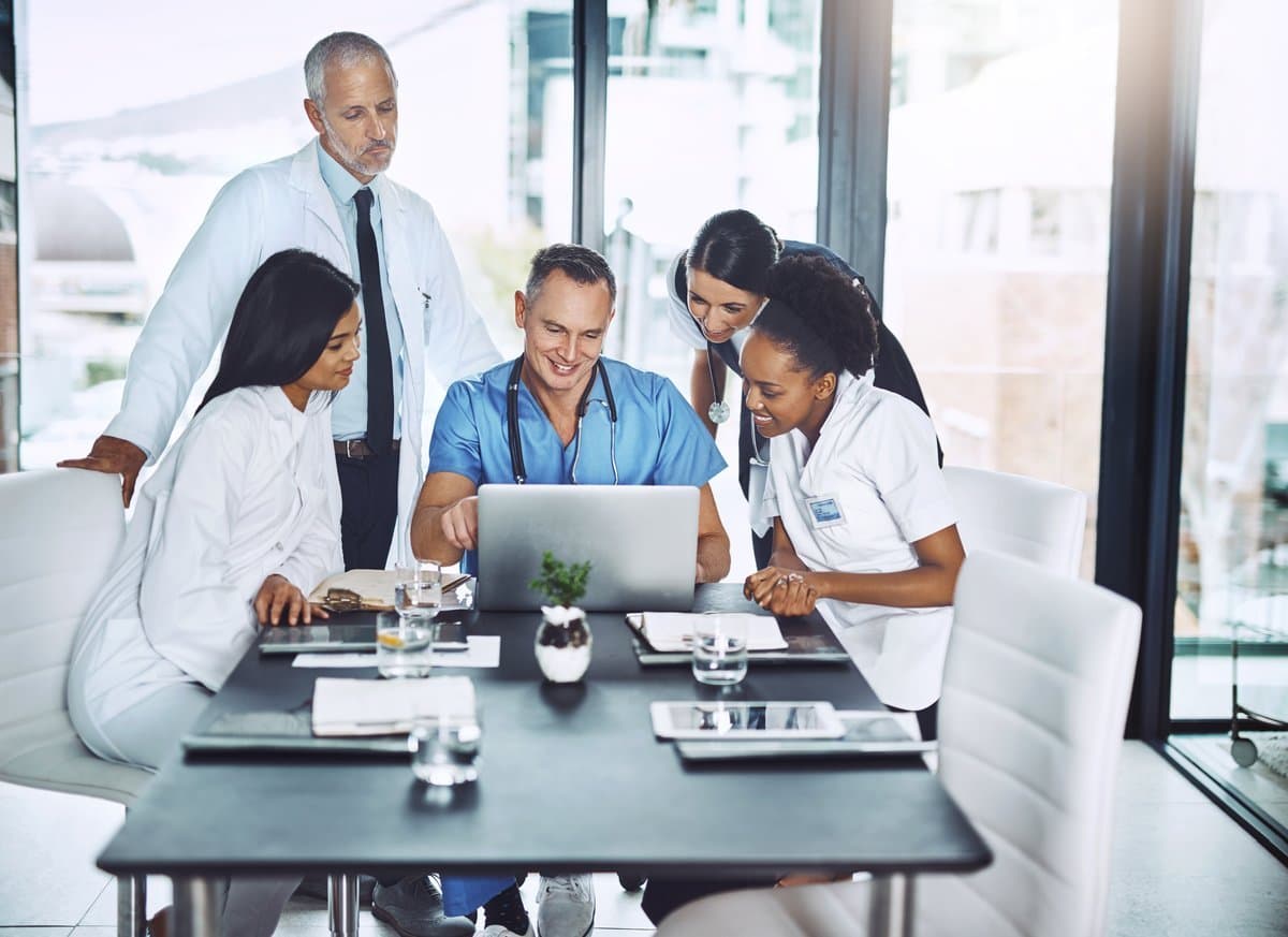 Medical professionals using intelligent scheduling technology for compliant roster generation