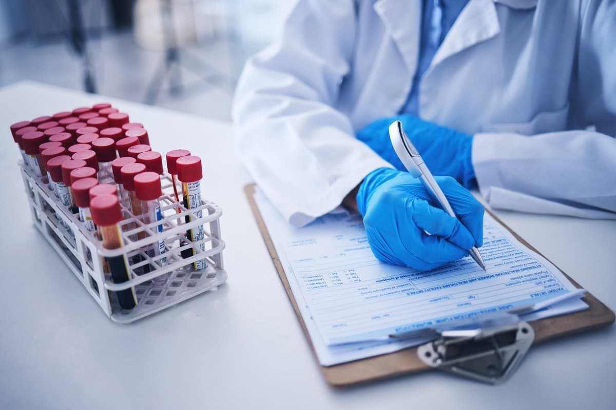 Medical professional reviewing compliance documentation and quality standards checklist