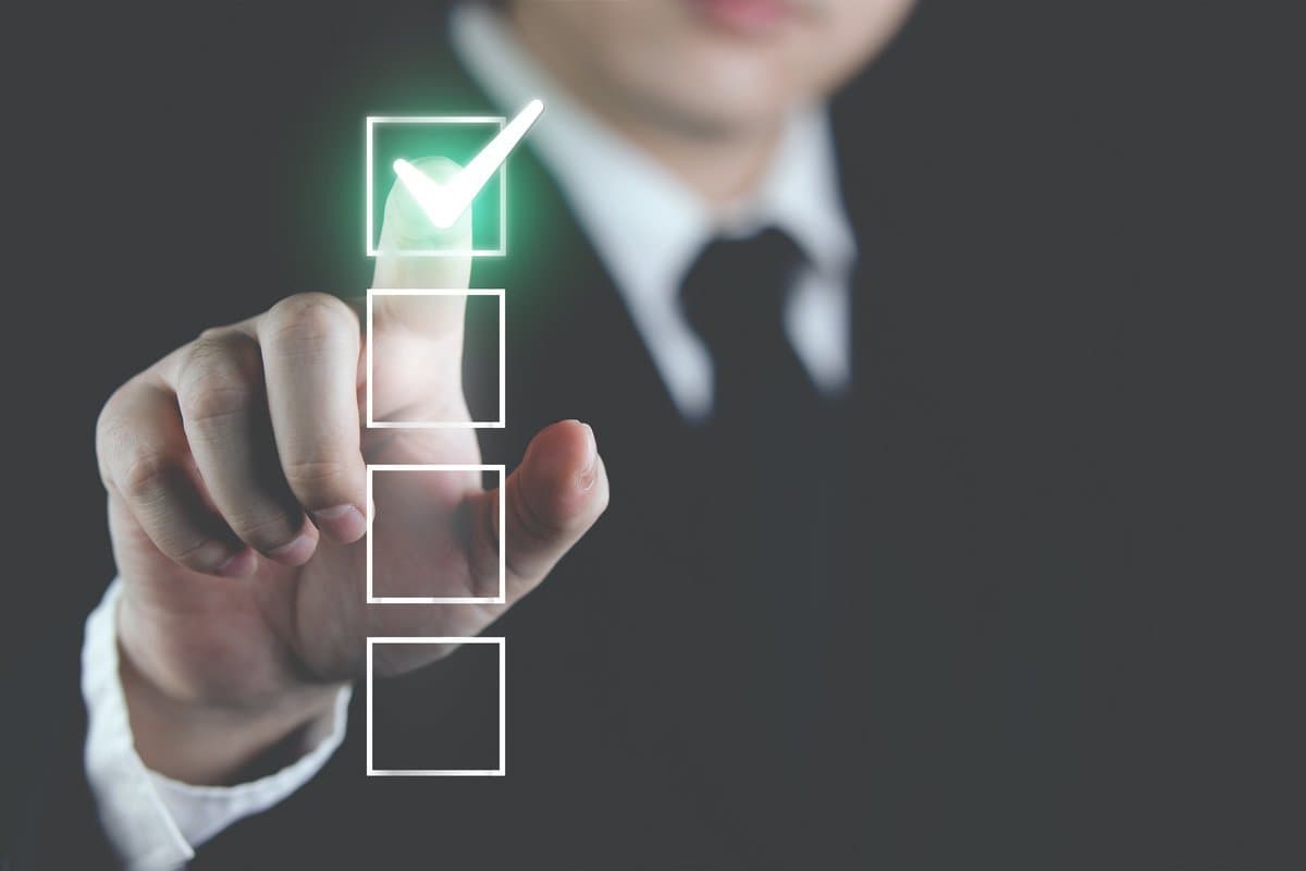 Professional reviewing validation dashboard with status indicators and compliance checks