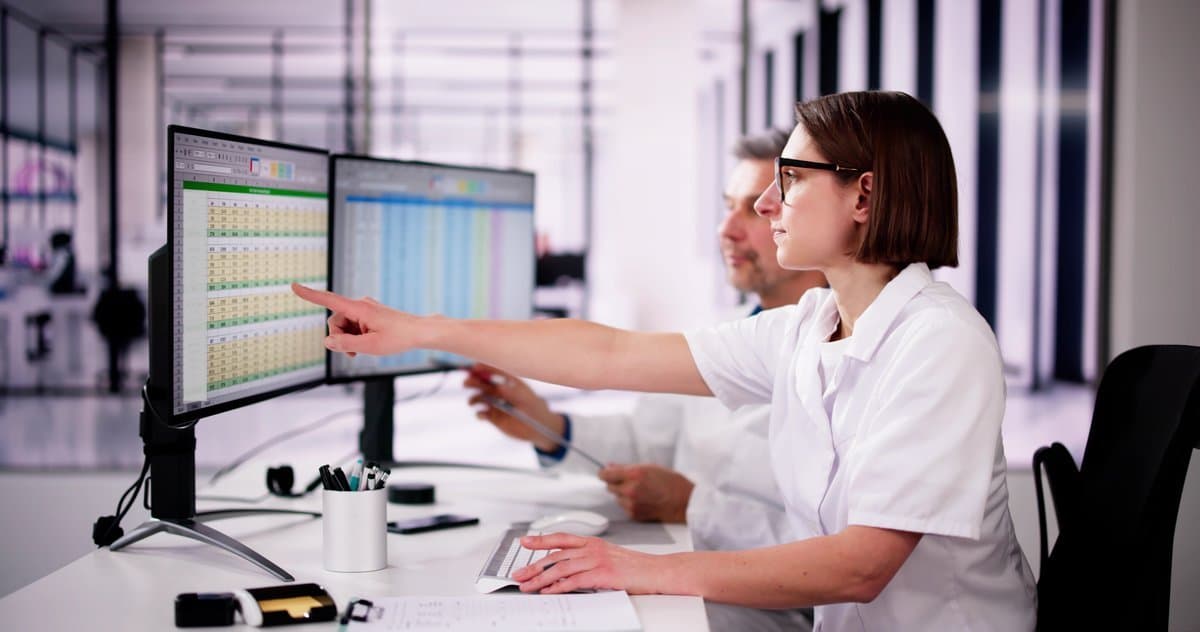 Professional managing complex scheduling data across multiple screens