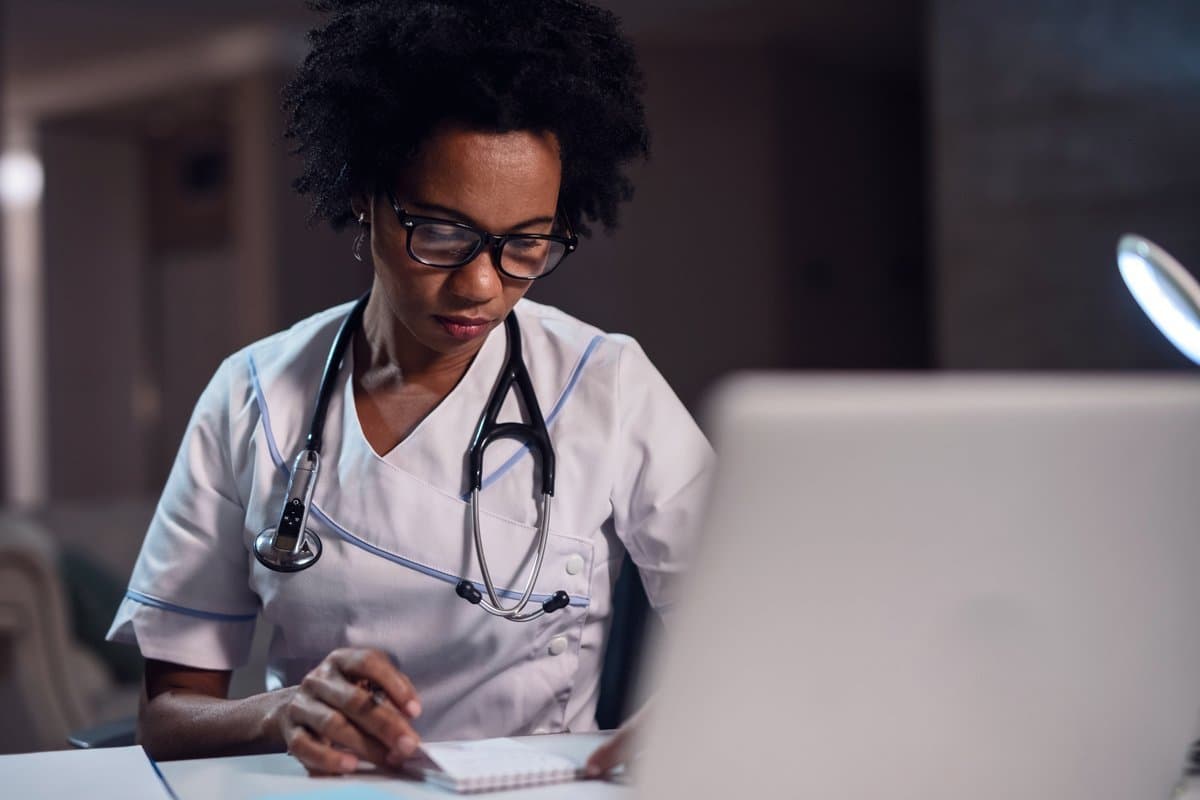 Healthcare professional evaluating scheduling options between spreadsheet and purpose-built software