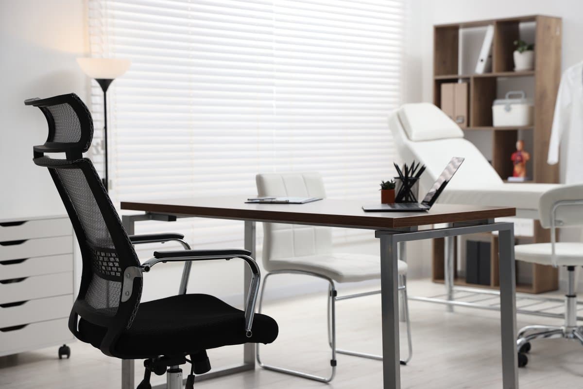 Empty chair at a professional meeting table representing the cost of staff departure