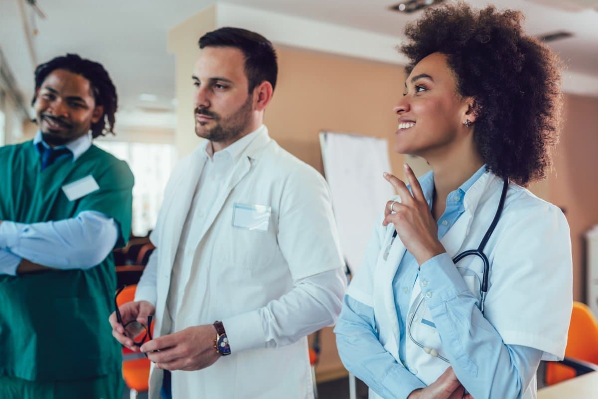 Small specialist medical team in a confident collaborative moment