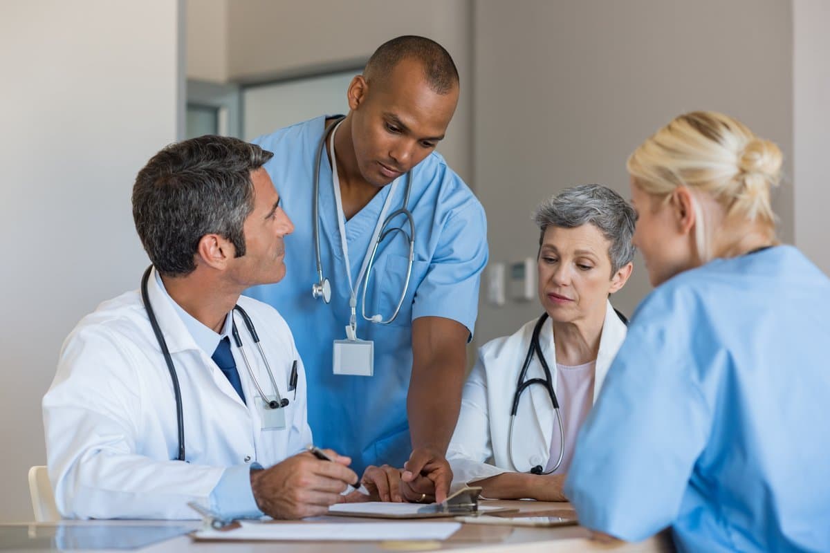 Specialist physicians in a serious professional discussion about practice management
