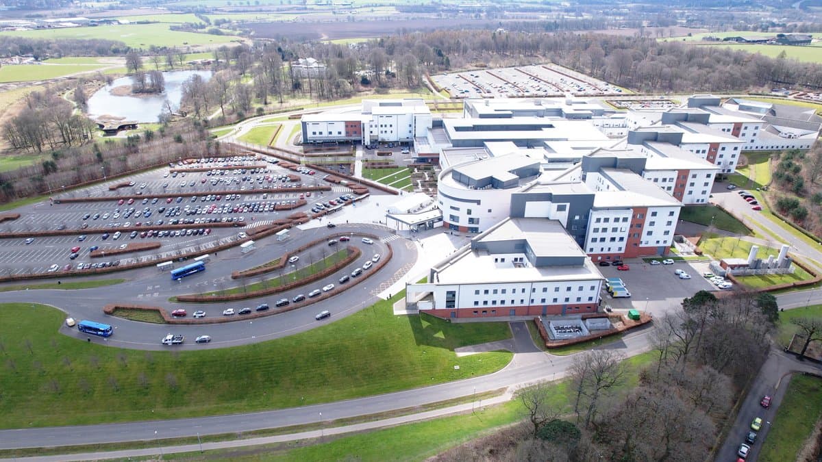 Aerial view of interconnected medical facility buildings representing a multi-site healthcare network
